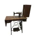 A late Victorian sewing machine table with Home Companion machine on rectangular moulded top with
