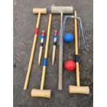 A croquet set with three beech mallets, hoops, two balls, a pair of posts, etc; and one old oak