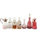 Four miscellaneous cut glass decanters & stoppers, all with hallmarked silver labels on chains,