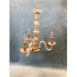 An Italian style glass chandelier with fluted glass column supporting three scrolled spiralled