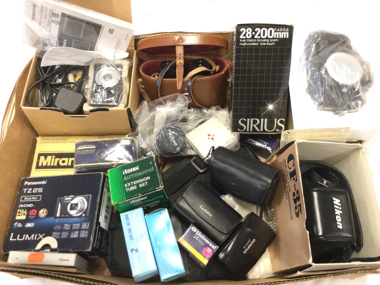 Miscellaneous camera gear including boxed Panasonic Lumixes, zoom lenses, Olympus, a flash unit,