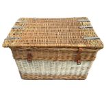 A cane laundry basket with rope handles and leather straps. (32in x 21.5in x 21.5in)