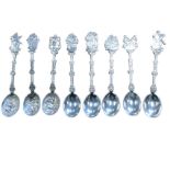 A set of eight Dutch silver spoons with embossed handles and oval bowls - fishermen, musicians, a