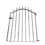 An arched wrought iron garden gate having vertical bars with ball finials. (29.75in x 41in)