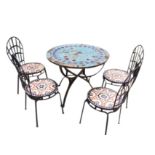 A set of four metal garden chairs with arched backs above tiled mosaic seats and metal table with