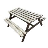 A rectangular garden table & bench set with slatted top and seats on angled supports. (58in x 51in x