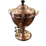 A Victorian copper urn with hardwood knob handle to cover, the trophy shaped vessel riveted with