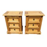 A pair of pine bedside cabinets with rectangular grooved tops above three panelled drawers mounted