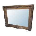 A large reproduction bevelled mirror in elaborate composition frame with pierced acanthus scrolled