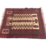 A Bokhara prayer rug woven with central serrated sword hung with pendants on fawn field, framed by