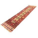 A rectangular Turkish wool runner woven with eight floral motifs on yellow field framed by red