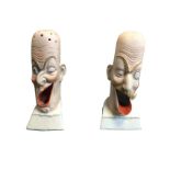 A pair of unusual porcelain characterful heads, modelled as old gentlemen with open mouths, one with