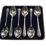 A cased set of six hallmarked silver golf spoons - Sheffield, Walker & Hall, 1933. (4.25in) (6)