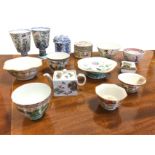 A collection of oriental porcelain including a pair of octagonal stem cups on stands, a pair of