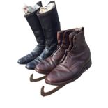 A pair of black leather riding boots with attached spurs; and a pair of brown leather skating