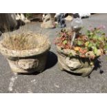 A pair of composition stone pots embossed with circular lion masks between ropetwist borders. (13.