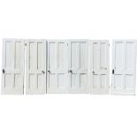 A set of six painted household doors, each with four moulded panels to both sides. (27in-32in wide x