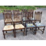 A set of four oak dining chairs with carved scrolled rails above slats framed by barley-twist