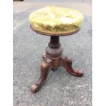 A Victorian rise & fall stool with circular cushion upholstered seat revolving on turned fluted