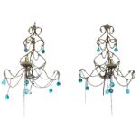 A pair of gilt wirework wall lights with scrolled frames festooned with glass beads and blue