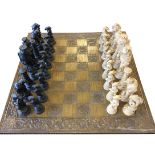 A composition Reynard the Fox chess set, with moulded figural prices including lions, wolves,