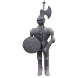 A painted metal armoured medieval type soldier, with vizored helmet, holding shield and