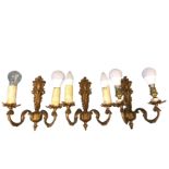 A set of three eighteenth century style brass wall lights with acanthus scrolled wallplates, each