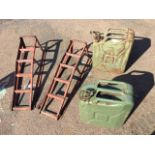 A pair of rectangular angle-iron car ramps; and two army jerry cans. (4)