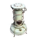 An Aladdin blue flame stove, the chimney with carrying handle above a fuel well and wick, with