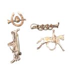 Four solid silver hunting stock pins or brooches, modelled as riding crops, horseshoes, caps,