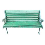 A rectangular slatted garden bench with cast iron ends, the scrolled arms on pierced floral