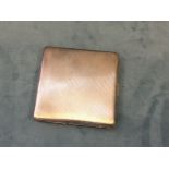 A square hallmarked silver cigarette case with engine turned decoration having silver gilt interior,