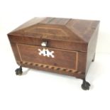 A nineteenth century mahogany box of sarcophagus shape decorated with geometric inlay and banding,