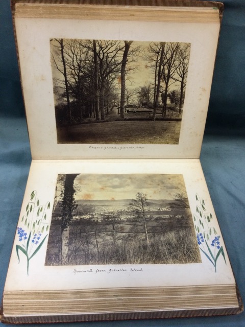 A leather bound Edwardian album of monochrome photographs and prints, many with floral watercolour - Image 2 of 3