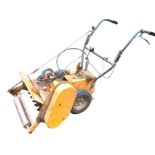 An industrial petrol driven garden scarifier with adjustable roller, pneumatic tyres, spare belts,