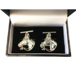 A cased pair of Stirling silver cufflinks modelled as horses heads with rope bridles, attached by