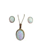 A 9ct gold parure with oval bezel set opals, the large .75in pendant stone having ropetwist border