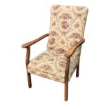 An upholstered cottage armchair with floral tapestry fabric, having padded back above a sprung seat,