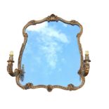 A Georgian style pier glass with wide plate in leaf moulded scrolled frame surmounted by a shell,
