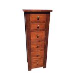 A reproduction oak column chest of six graduated drawers, with panelled top and sides, the drawers