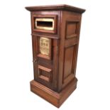 A mahogany country house style letterbox, the panelled cabinet with moulded cornice having a locking