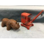 A childs Tri-ang toy crane on wheels; and a leather upholstered rhinoceros with bead eyes. (2)