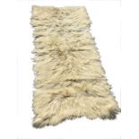 A rectangular Chinese goatskin rug. (54in x 24in)