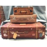 A Giovanni leather suitcase with straps; a leather suitcase with chrome mounts; and a 30s suitcase