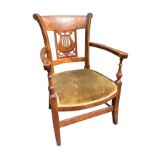 A Victorian armchair with shaped barback above a pierced lyre carved panel, the rounded arms on
