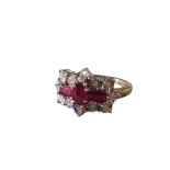 A 9ct gold hallmarked ruby & diamond ring, with three claw set baguette cut rubies in the form of