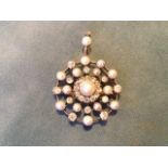 A circular spiders web style pearl and diamond gold brooch, set with radiating alternating pearls