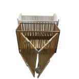 A painted cot with arched tongue & groove style ends having slatted sides; another smaller cot