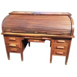 A Globe Wernicke & Company rolltop estate desk, with tambour enclosing small drawers, pigeonholes,