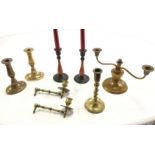 A pair of brass candlesticks on oval bases; another pair with baluster turned wood columns; a